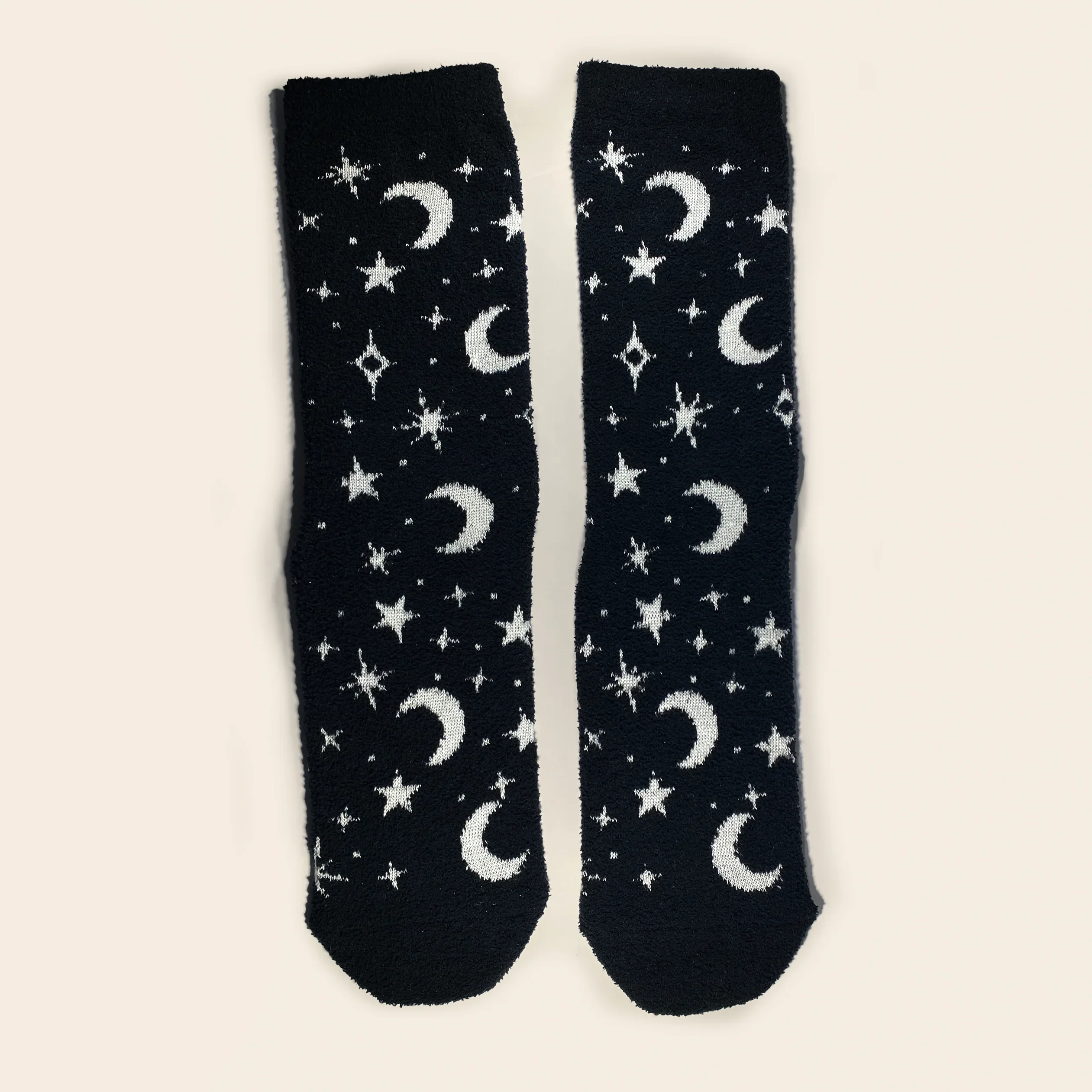 Black socks with white moon and star patterns on a beige background
Celestial glow-in-the-dark cozy socks with star and moon pattern by Velanyx

Soft plush gripper socks that glow in the dark in celestial design

Black cozy socks with glow star pattern and non-slip bottoms

Witchy celestial glow socks perfect for cozy nights and gifting

Velanyx glow-in-the-dark star socks ultra soft plush material