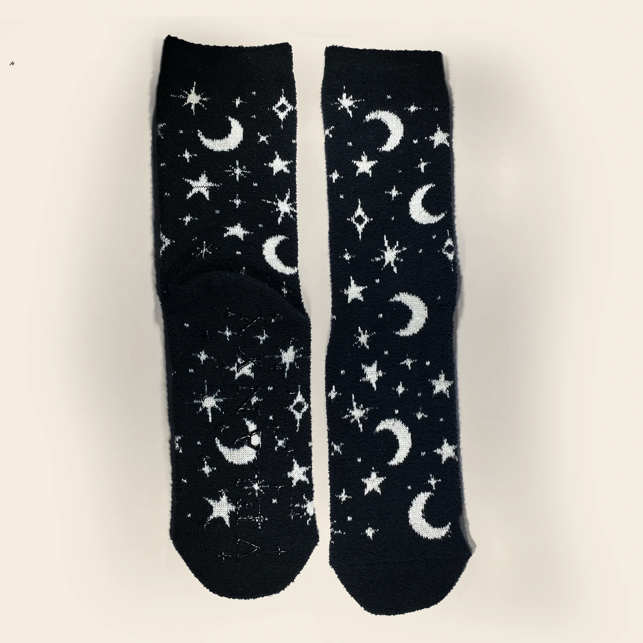 Black socks with white star and moon patterns on a light gray background
Celestial glow-in-the-dark cozy socks with star and moon pattern by Velanyx

Soft plush gripper socks that glow in the dark in celestial design

Black cozy socks with glow star pattern and non-slip bottoms

Witchy celestial glow socks perfect for cozy nights and gifting

Velanyx glow-in-the-dark star socks ultra soft plush material